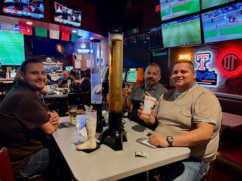 Beer Tower Night: Friends share a tower of cold beer.